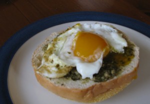Fresh egg with pesto on a toasted bagel - yum!